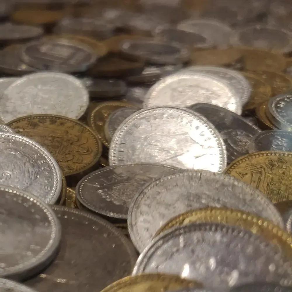 Close-up of a pile of old silver and bronze coins